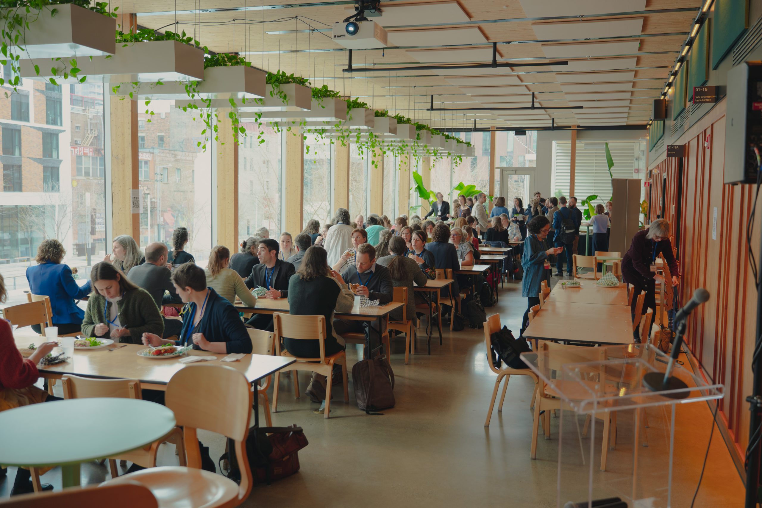 People are sitting in a brightly-lit room.